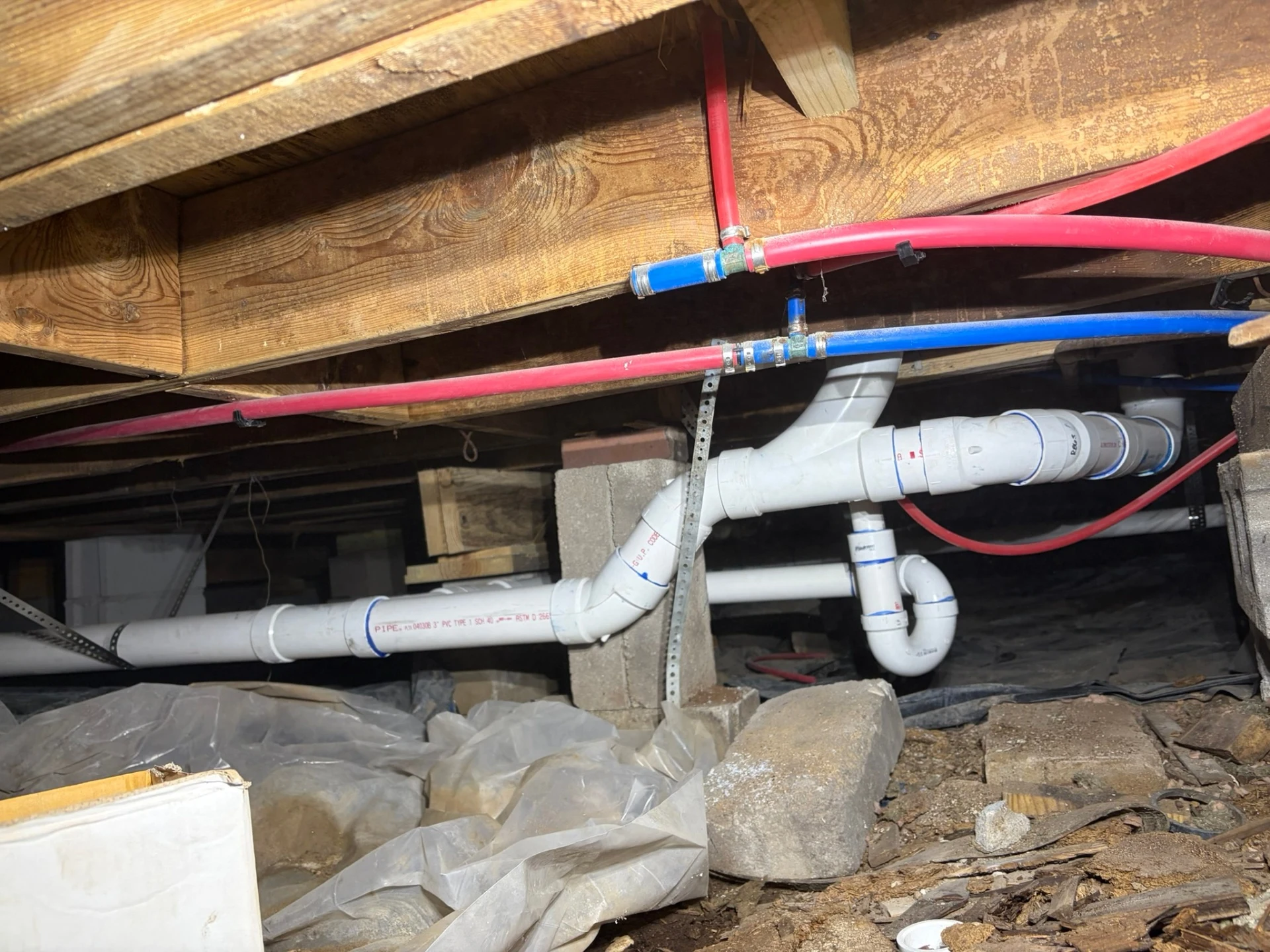 Completed PVC sewer drain repipe in a Rogers, Arkansas crawlspace by United Plumbing.