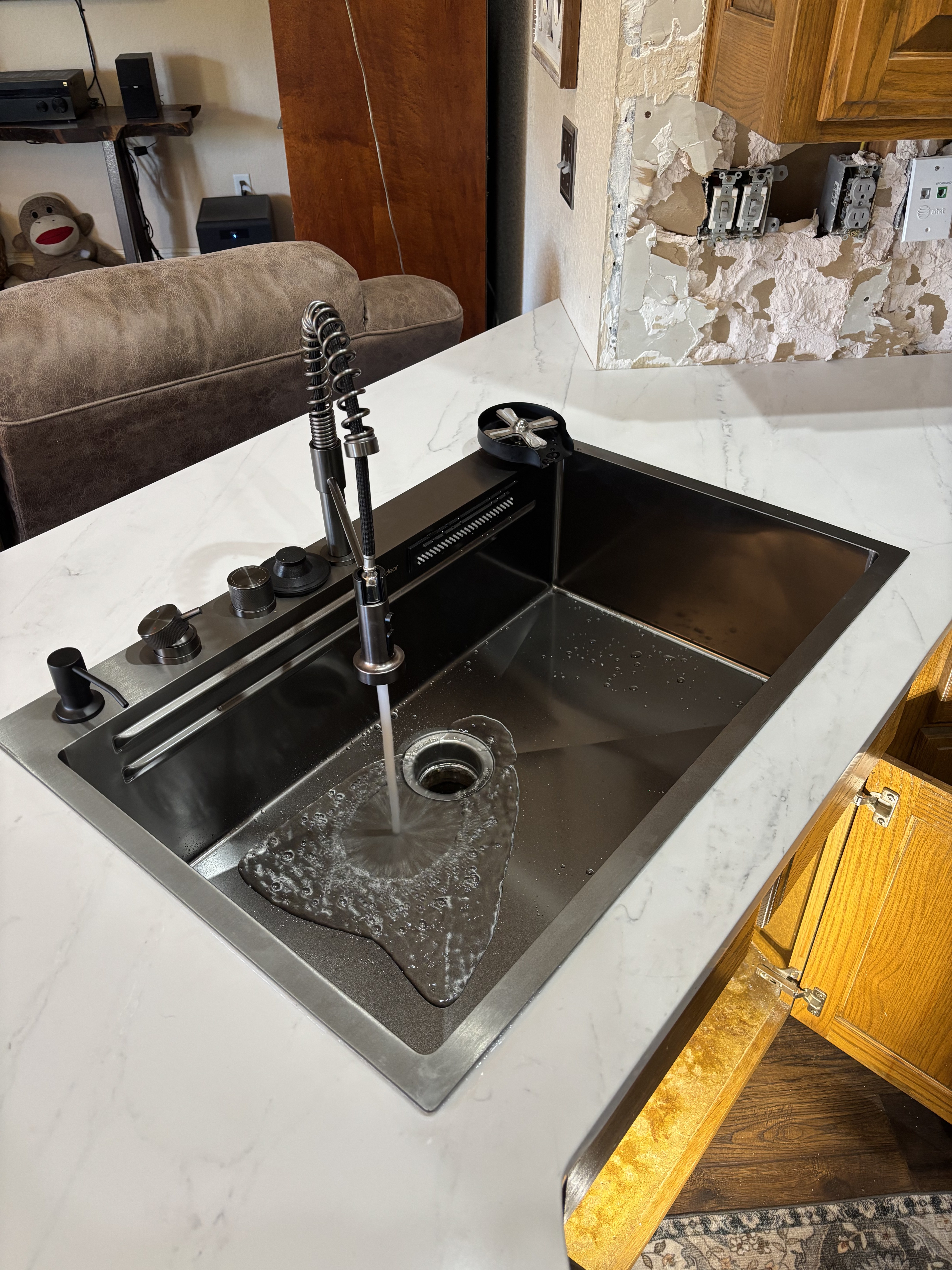 Completed kitchen faucet and workstation sink installation by United Plumbing.