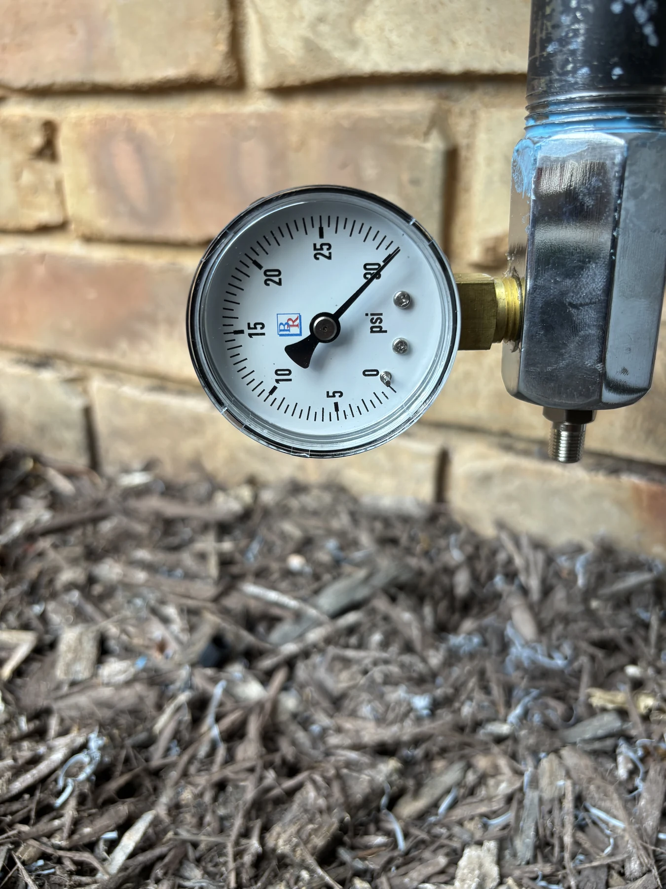 Pressure-test gauge attached to the new generator gas line during inspection in Fayetteville, Arkansas.