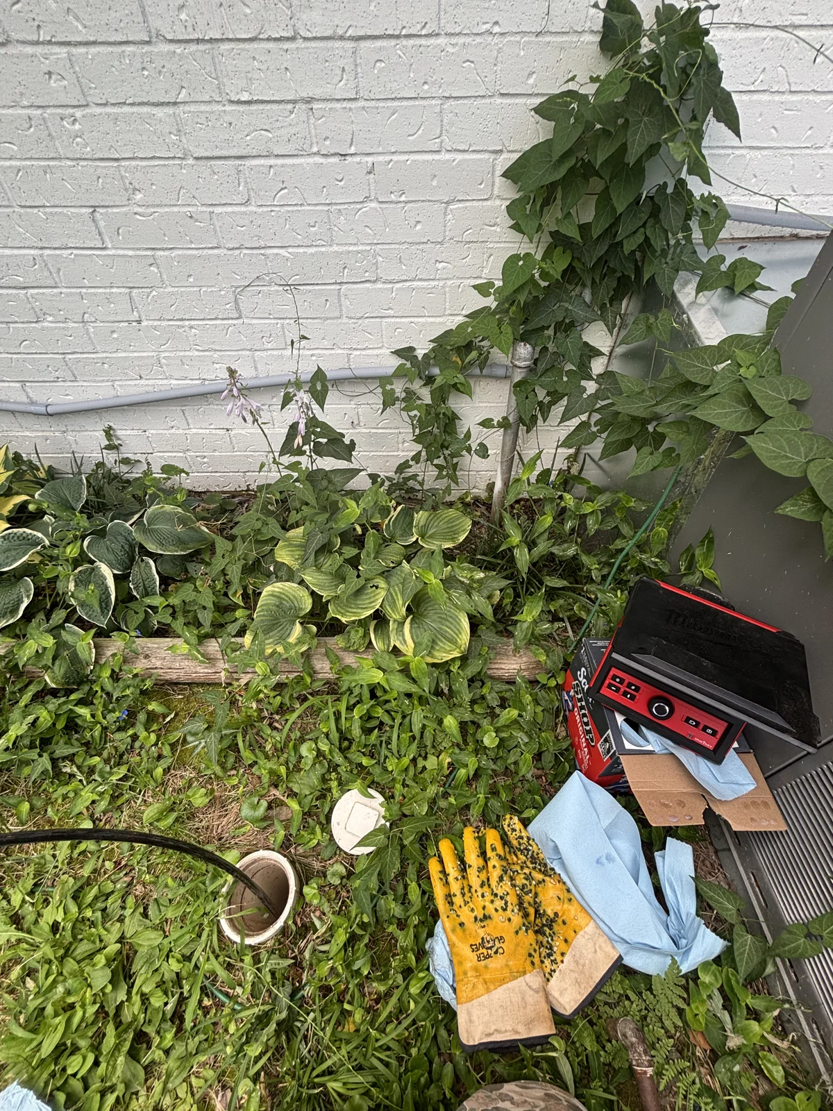 Sewer camera monitor and open cleanout during a camera inspection in Bentonville, Arkansas.