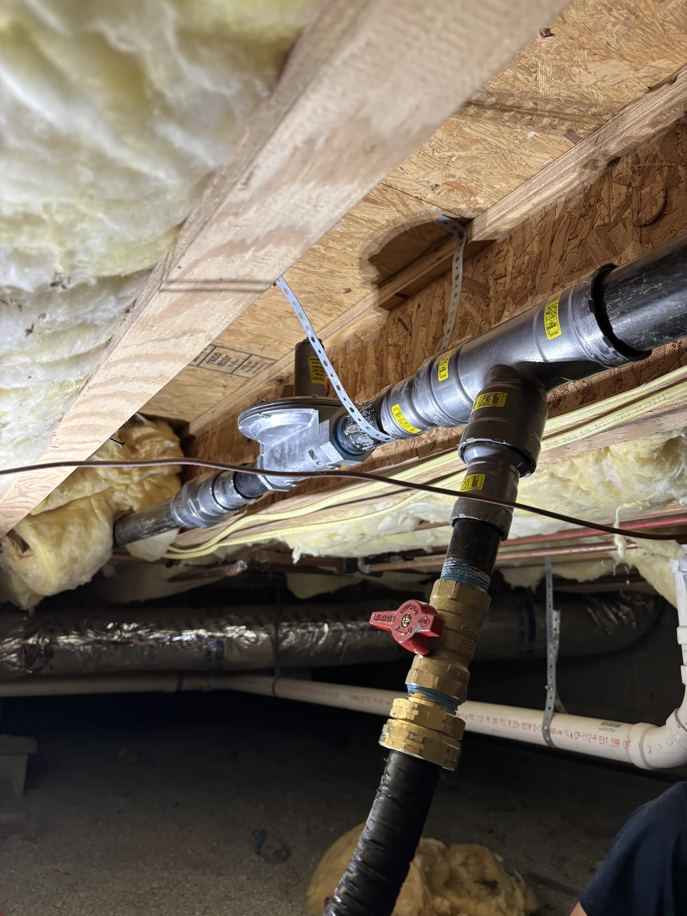 New natural gas piping secured beneath a Fayetteville property for a generator supply line.