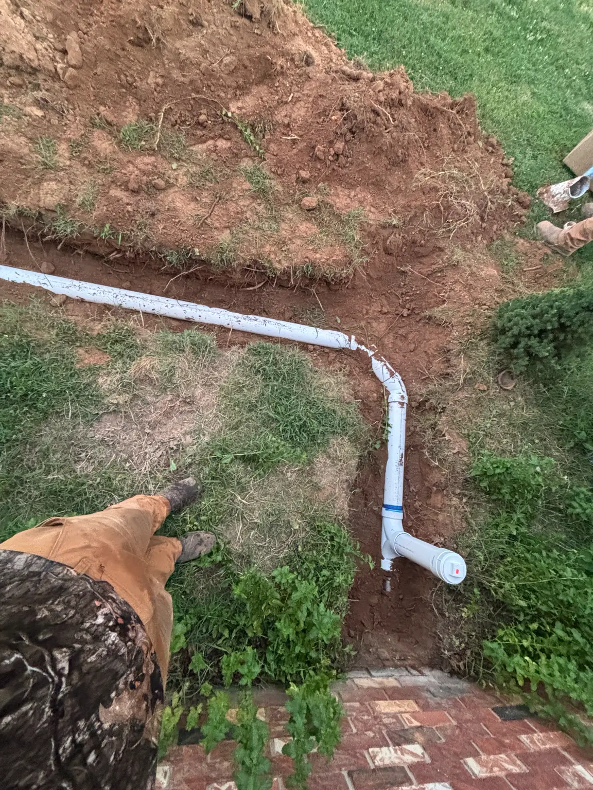 New PVC sewer connection and exterior cleanout installed in Rogers, Arkansas.