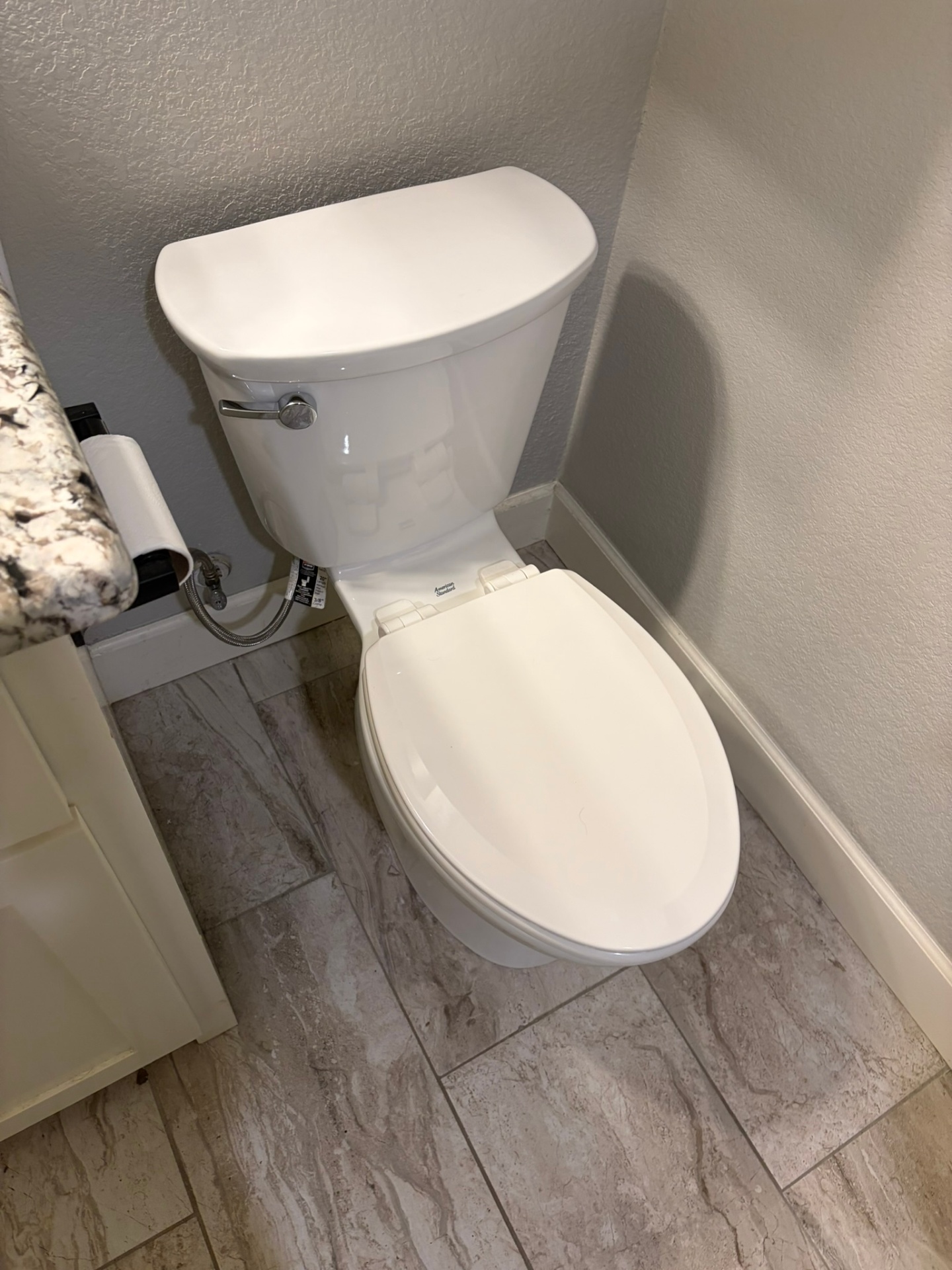 Completed toilet installation by United Plumbing with new supply line and shut-off valve.