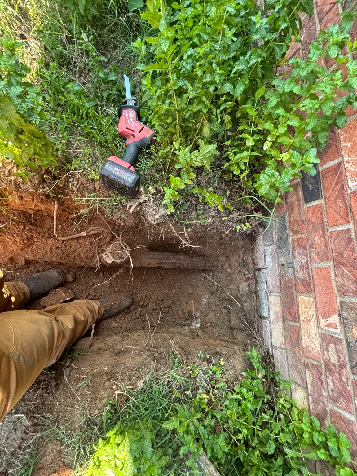 Existing bellied residential sewer line exposed in Rogers, Arkansas.