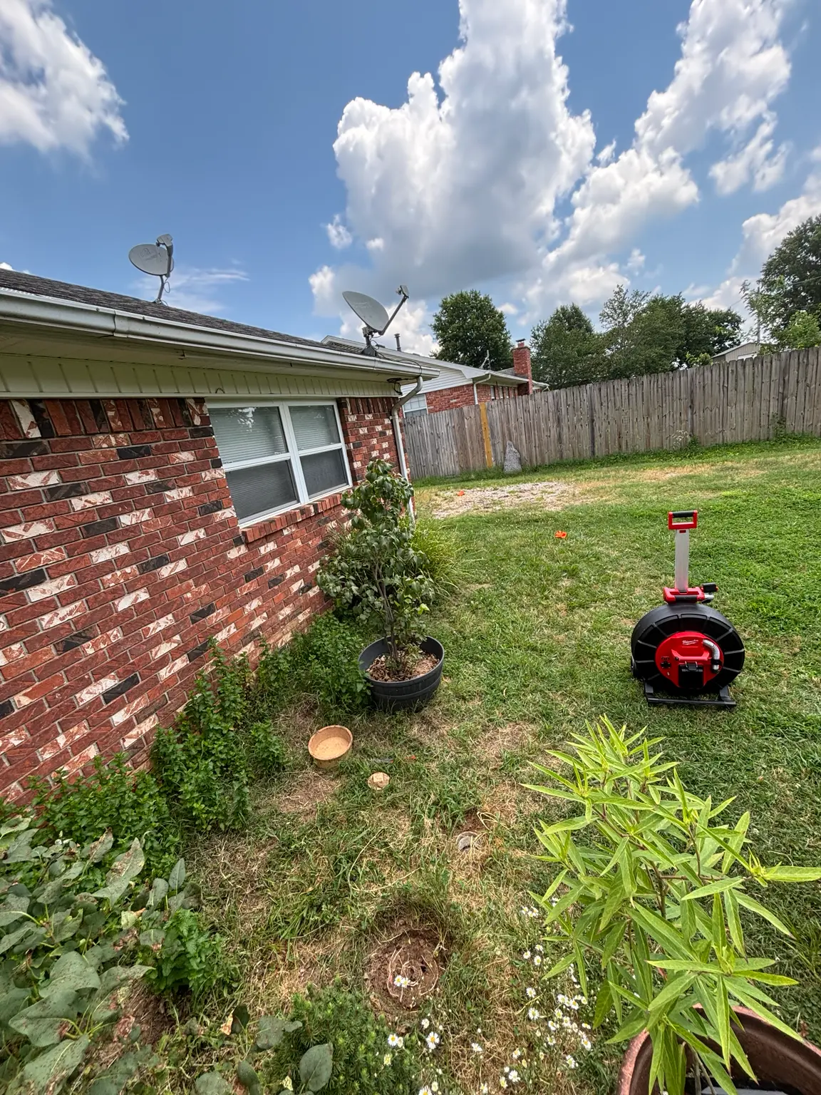 United Plumbing locating a residential sewer line in Rogers, Arkansas.